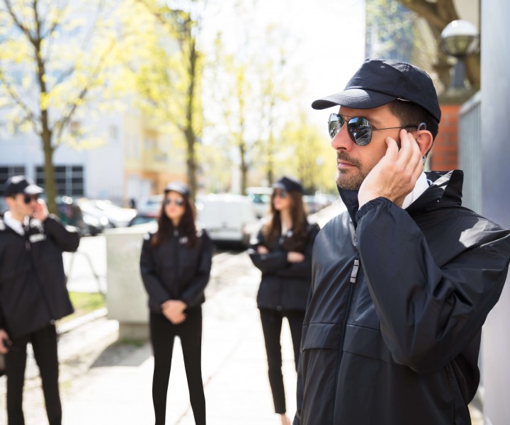 Close-up Of A Young Male Security Guard Listening With Earpiece